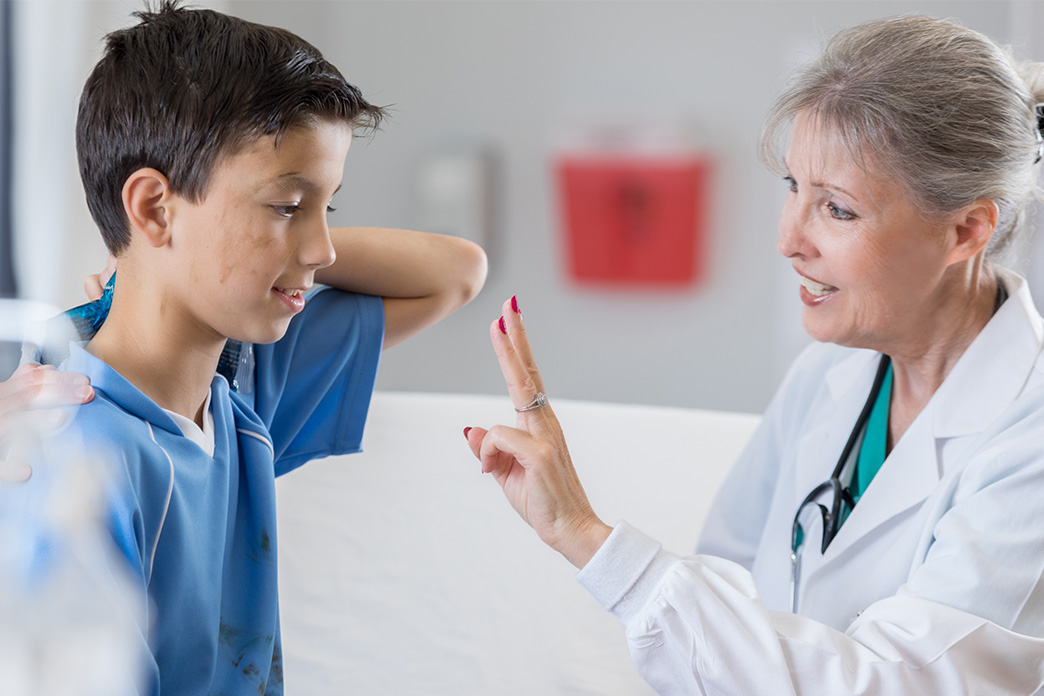 doctor conducting concussion protocol on a boy patient